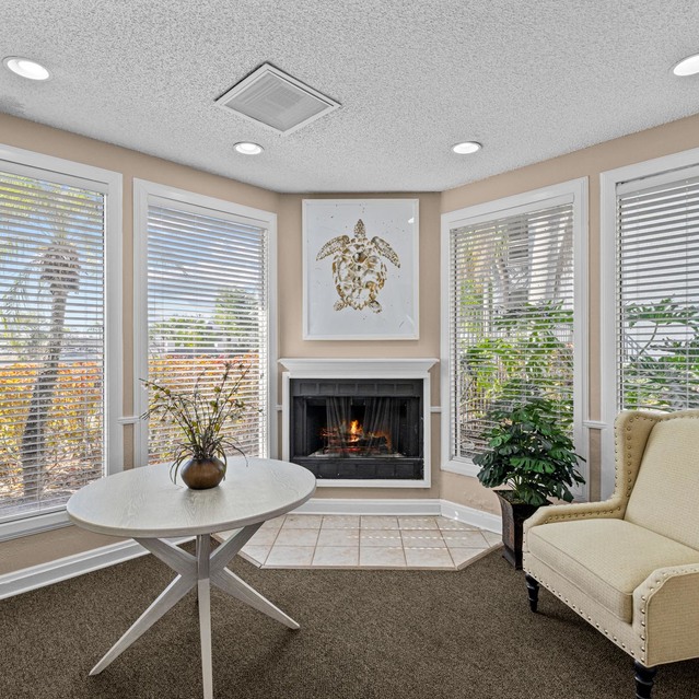 The Park at Veneto - Cozy Corner with a Cream Chair, Round Table, and Fireplace